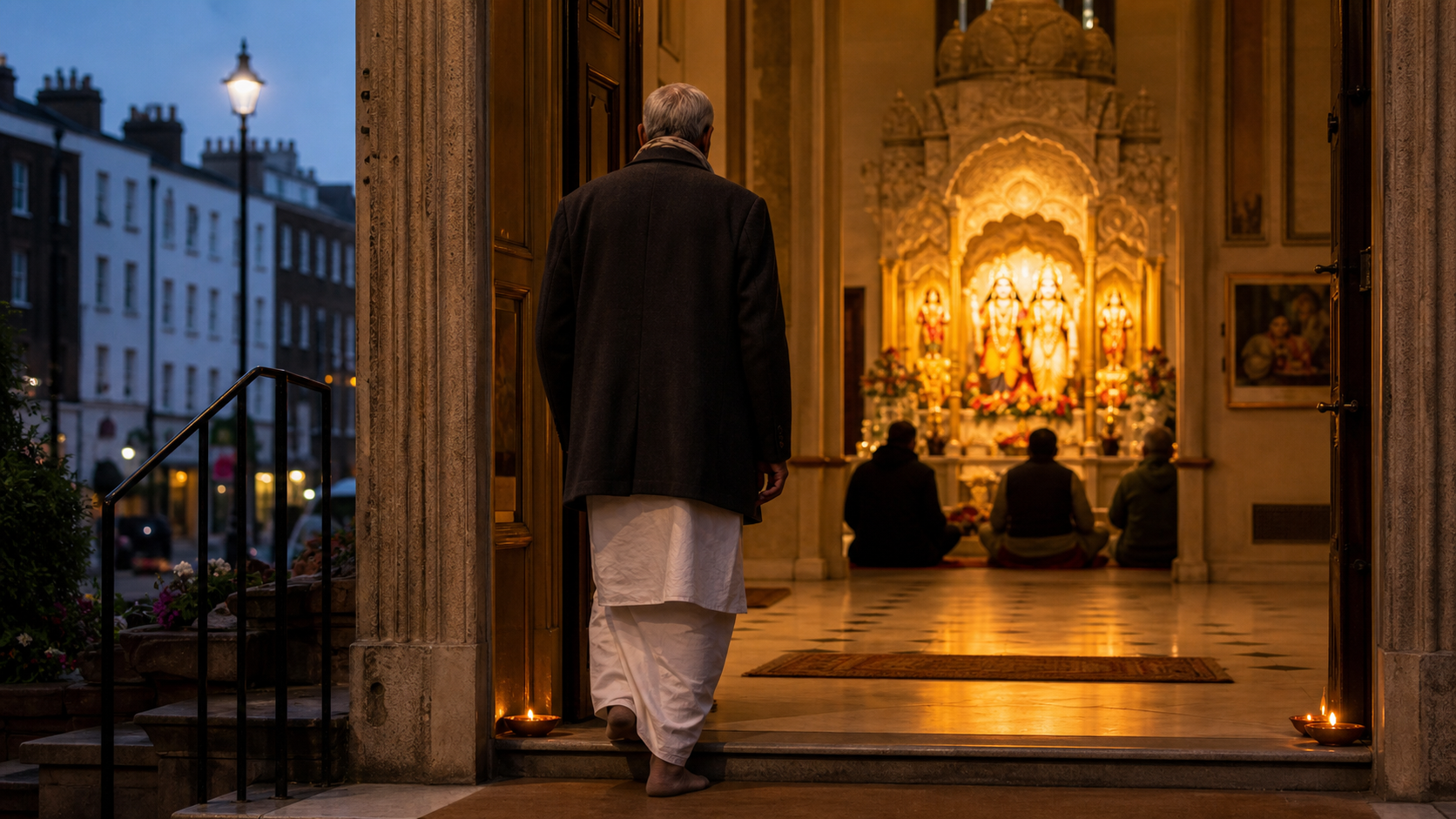 An elderly South Asian man enters a warmly lit Vaishnava temple at dawn while several devotees sit near the shrine inside.