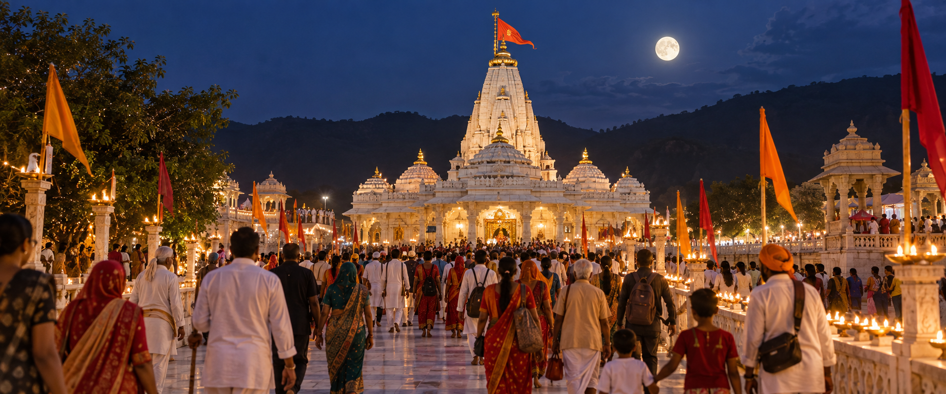 Pilgrims approach the illuminated Ambaji temple beneath a full moon during an evening observance in Gujarat.