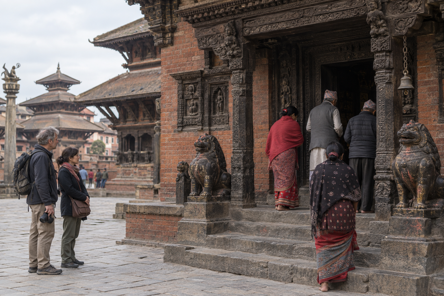 Visitors stand quietly to one side while local worshippers approach the public entrance of Bhairavnath Temple.