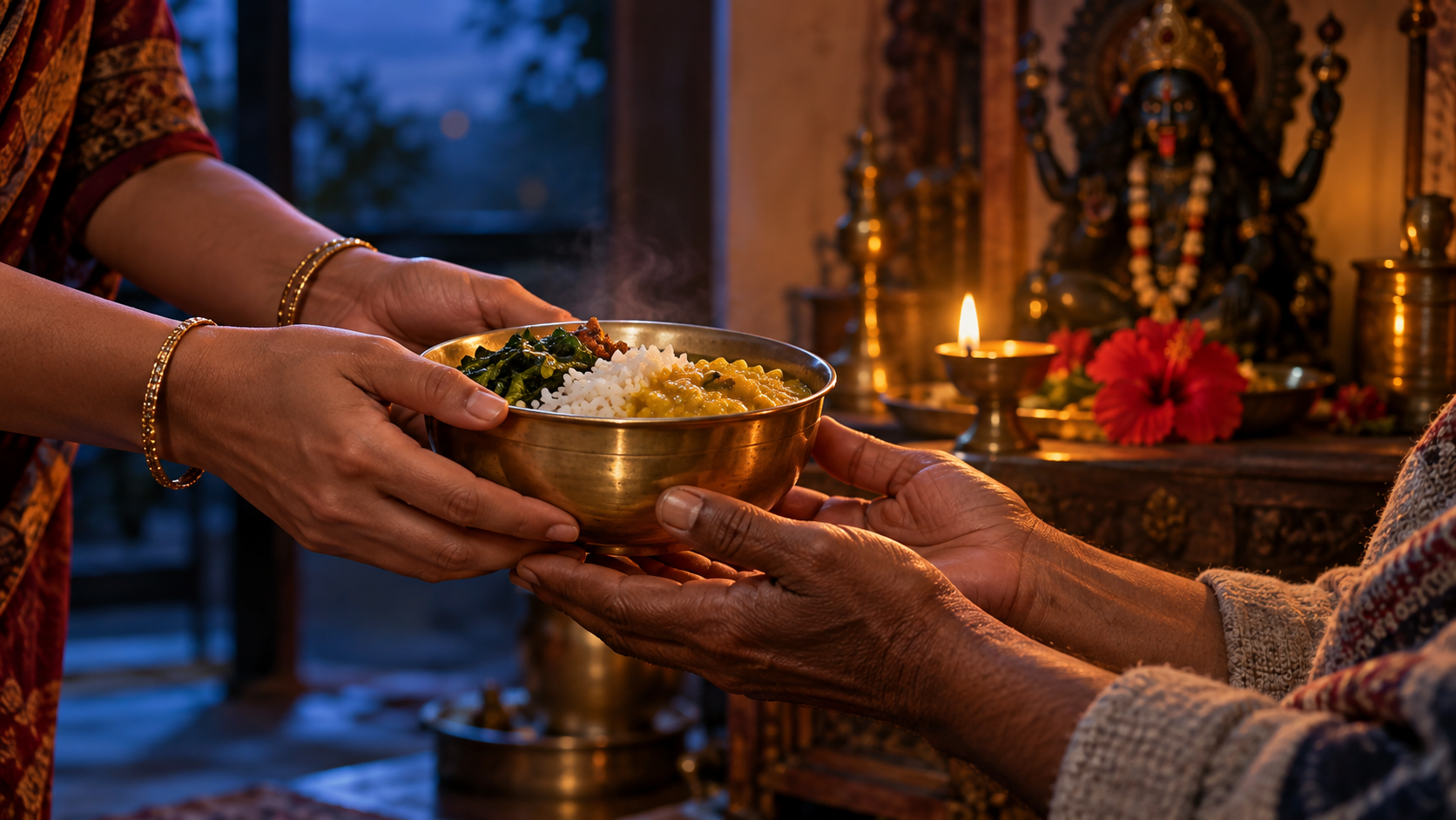One person offers a bowl of food to another as blue and golden light meet around their hands, with a Kali Puja lamp in the background.